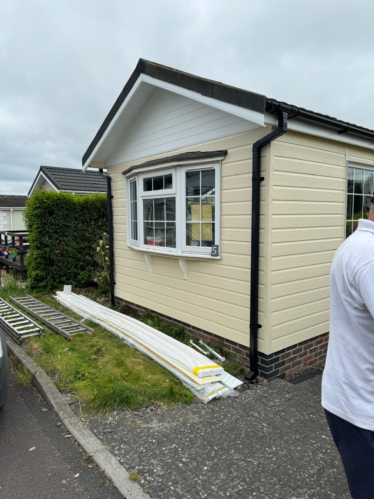 Park home after renovation — new cream cladding with white windows