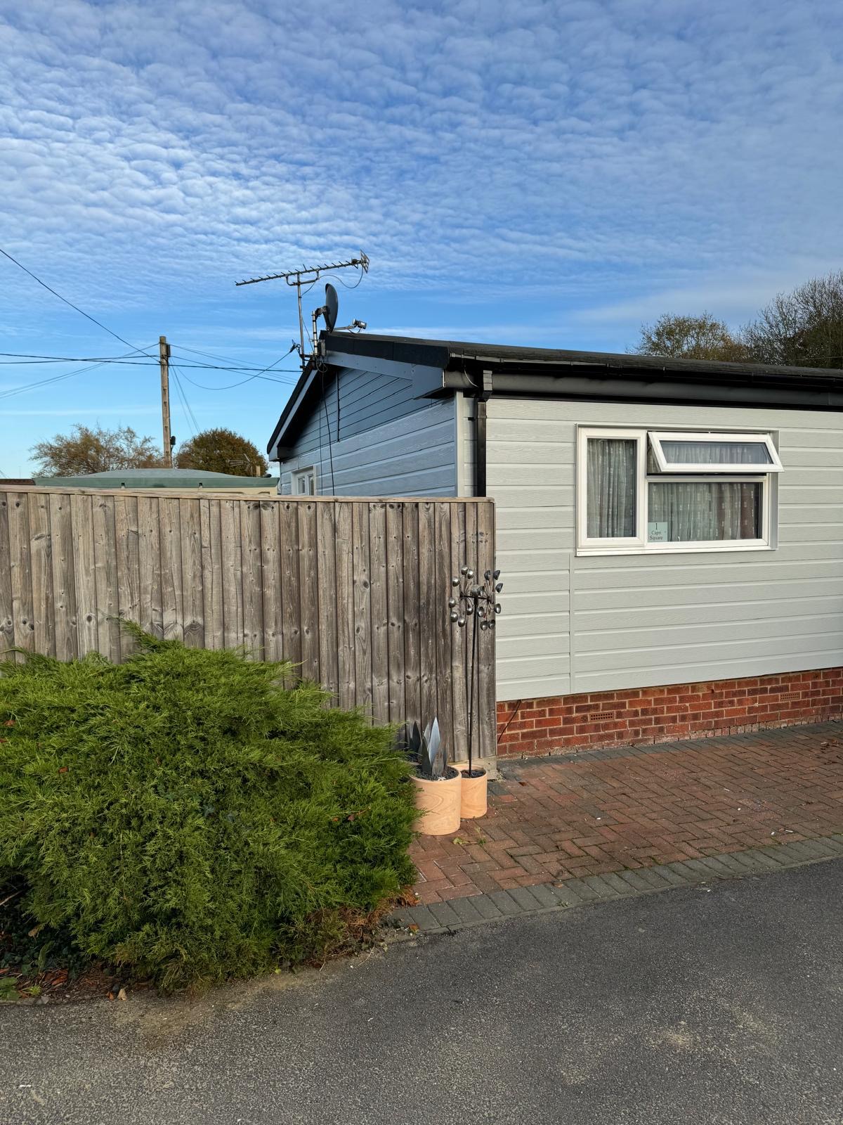 Completed park home renovation with fresh cream cladding and driveway